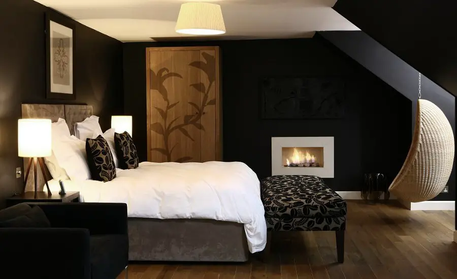 Black Bedroom with Decorative Fireplace