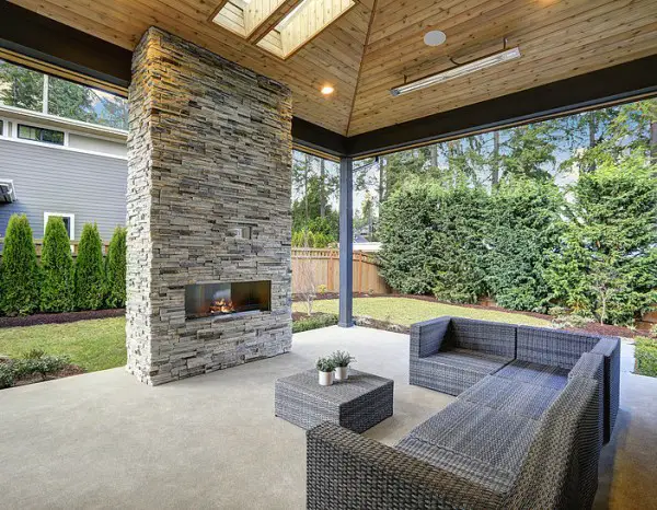 Chic Patio Design With Vaulted Ceiling And Stone Fireplace    