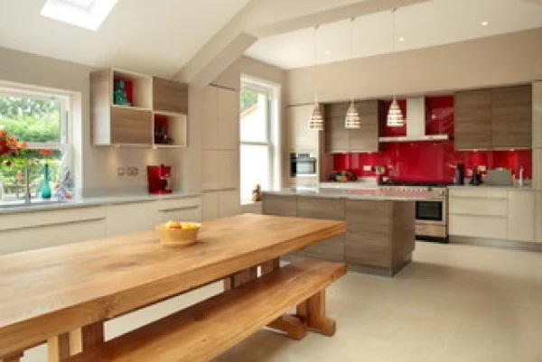 Contemporary kitchen with red splashback and vaulted ceiling    