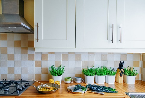 White shaker cabinets and a mosaic backsplash 