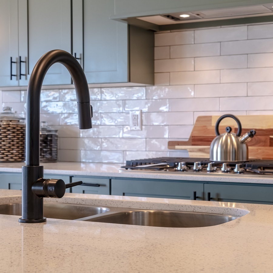 black faucet on a stainless kitchen sink