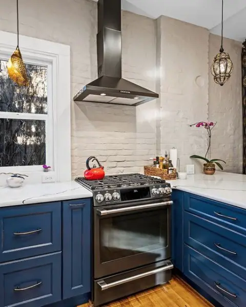 Tea Pots are Red, Cabinets are Blue, Marble Countertops, Design by KE for you kitchen with brick backsplash