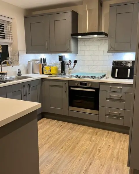 The Roberts' Kitchen kitchen with grey cabinets