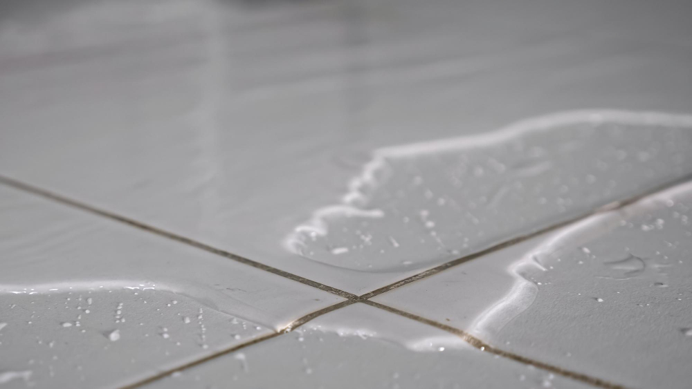 water in floor tiles inside home