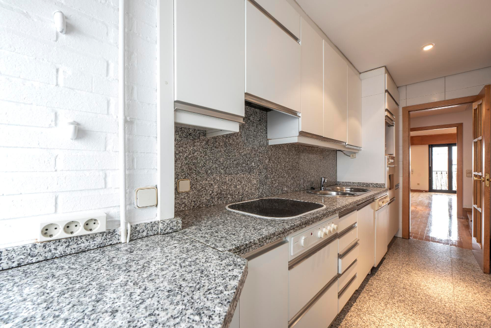 Black Granite countertop with white cabinet