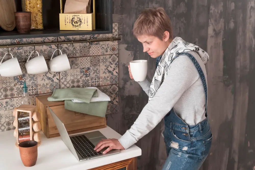 woman using laptop in kitchen