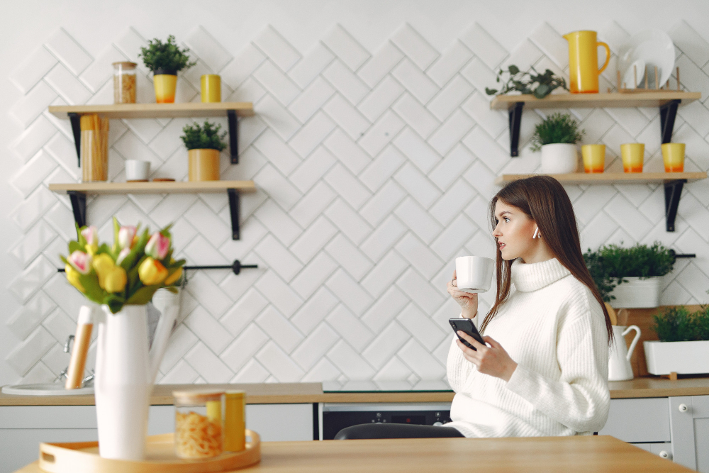 lady in kitchen with open shelves