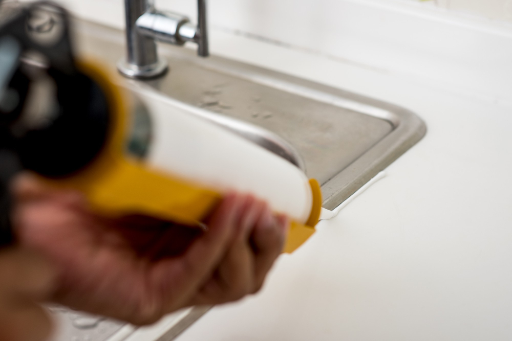 Applying Sealant and Caulking New Kitchen Sink