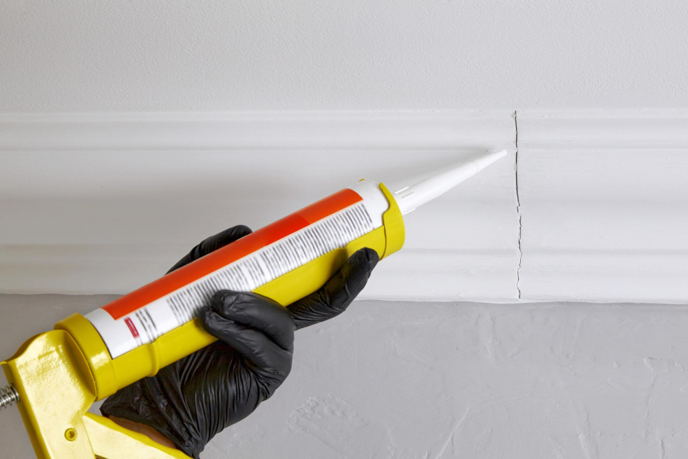 Sealing Gaps and Cracks Under Kitchen Cabinet Using Caulking Gun Silicone