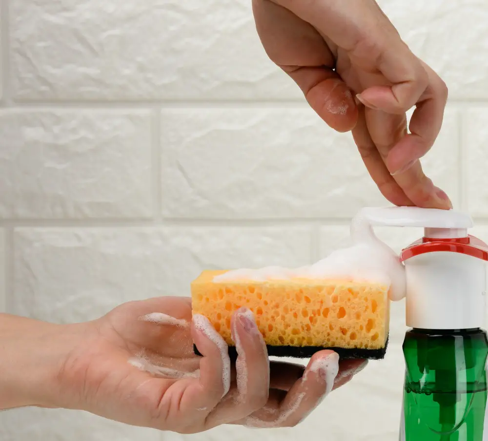 pressing down dish soap dispenser testing kitchen sponge