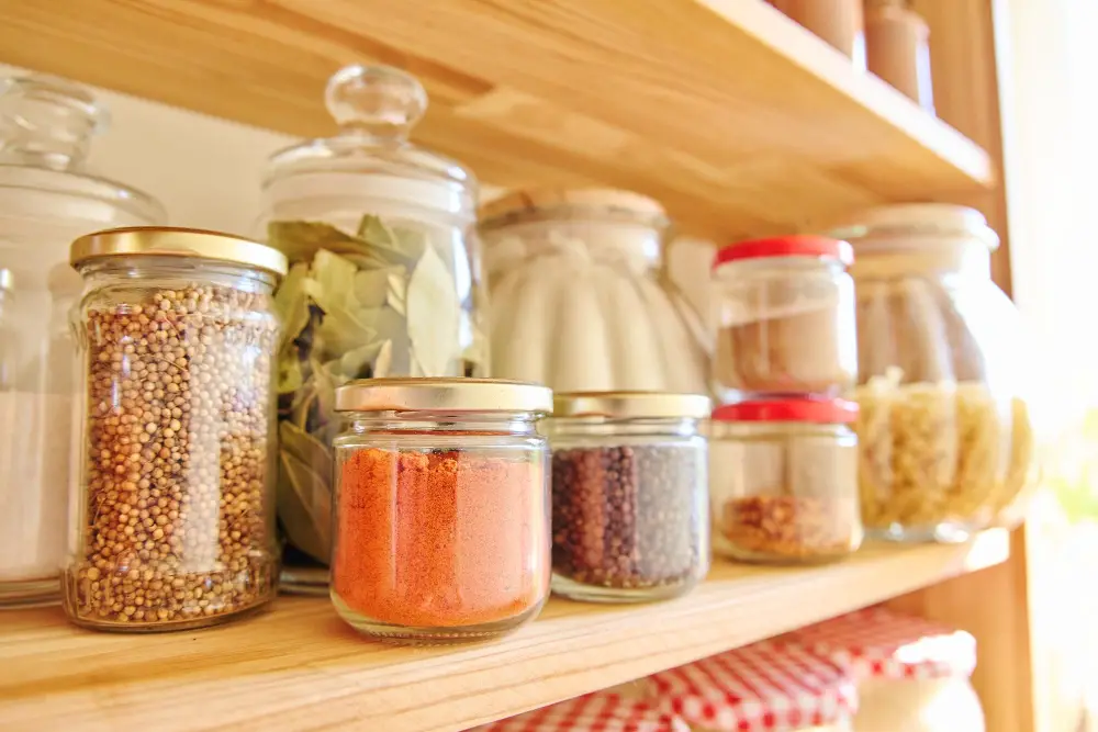 Apothecary jars with bay leaves spice herbs kitchen pantry