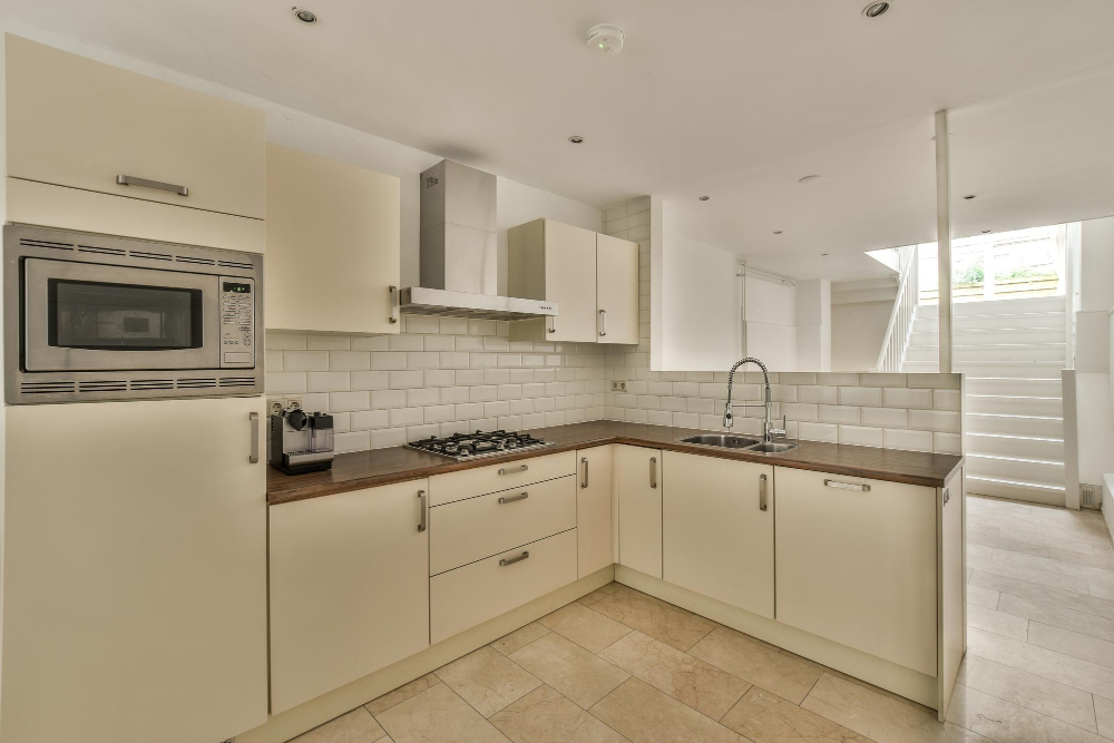 Cream Kitchen Cabinets with Stainless Steel Hardware