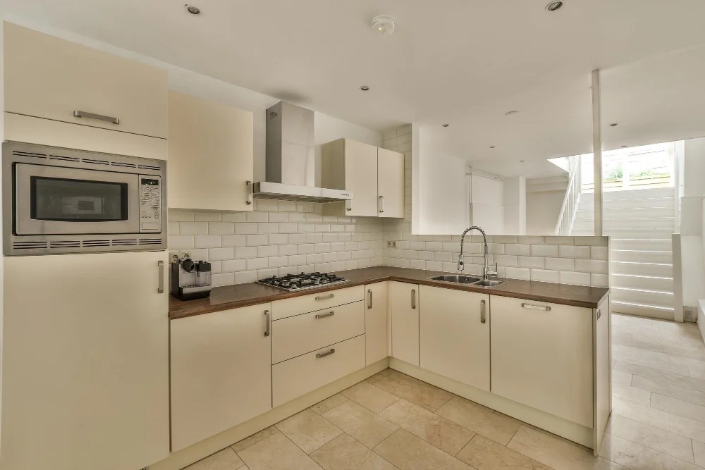 Cream Kitchen Cabinets with Stainless Steel Hardware