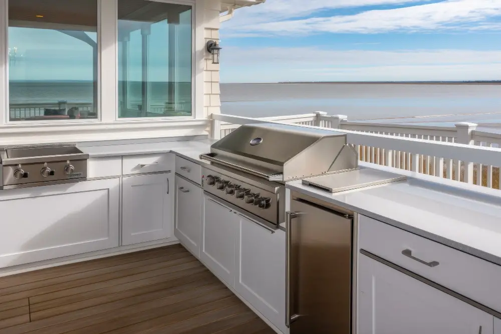 white marine-grade polymer cabinetry outdoor kitchen deck with grill ocean beach